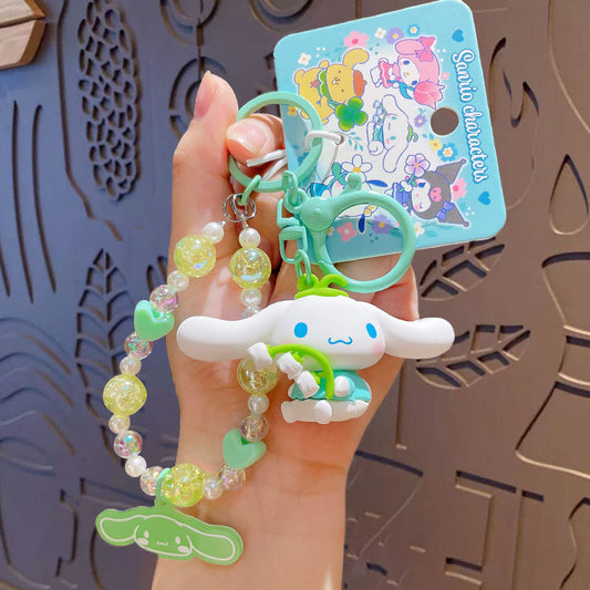 Sanrio - Cinnamoroll - Sleutelhanger – Tranquil Floral Serie – Schattig Sleutelaccessoire met Parelmoer Kralen – 7 cm – Perfect voor Tassen, Autosleutels & Cadeaus voor Kawaii Liefhebbers